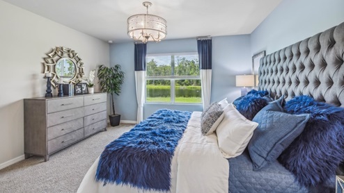 Inside of the Jemison model bedroom two. Grey carpet with off-white walls. Room contains one bed, a nightstand next to the bed, and dresser on the opposing wall. Room also contains a window.
