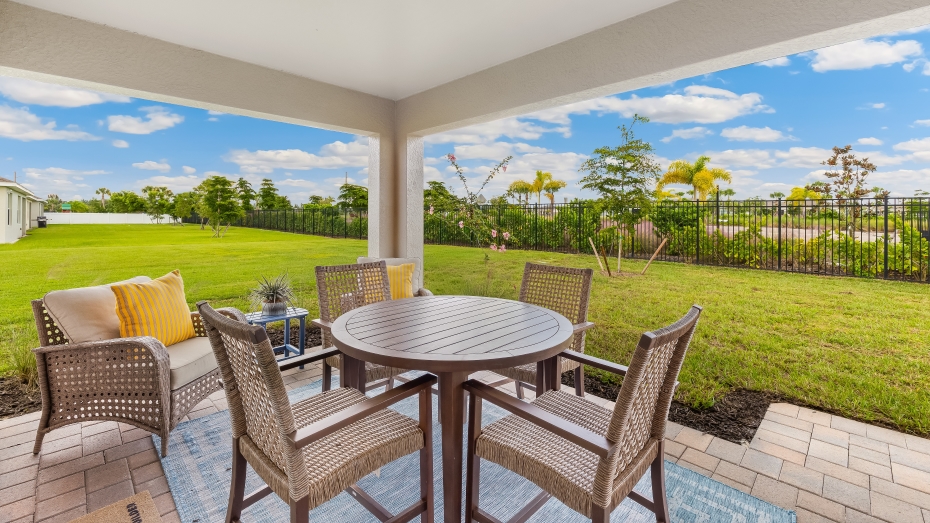 Patio of the Jemison model. Screened in patio with a table and seating for 4. There is also a side chair.