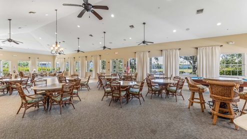 Inside the amenity center club house event space with game tables