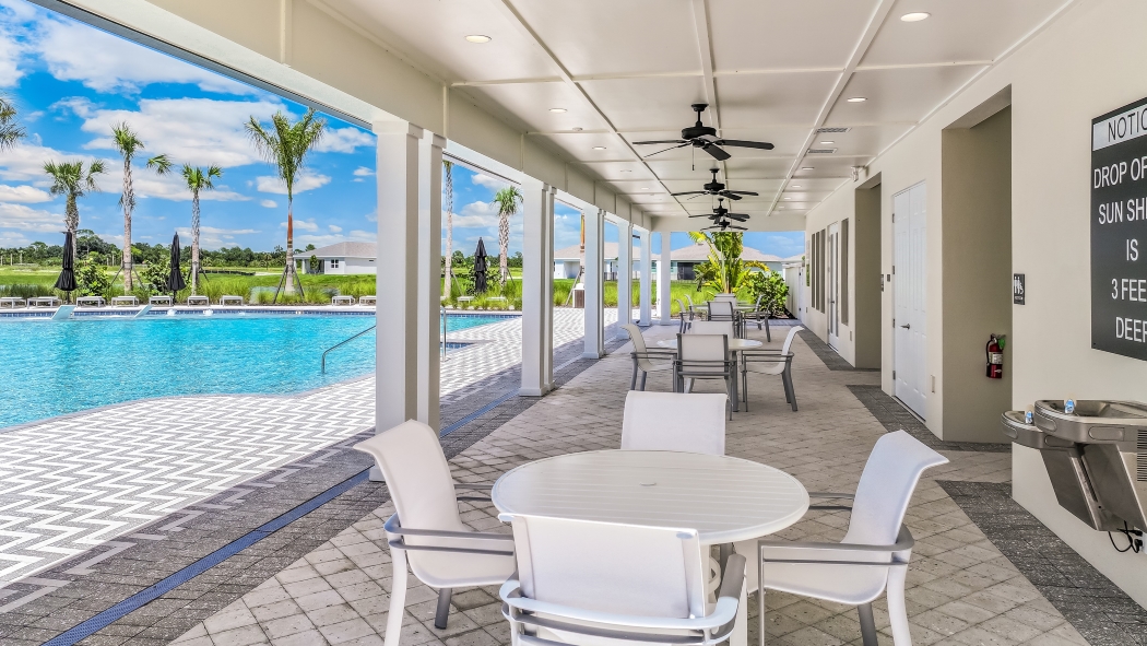 Outside of the amenity clubhouse seating area by the pool