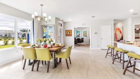 Dining area is featured with a view into the den and kitchen.