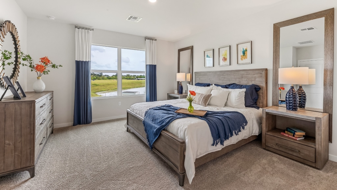 Another angle of the primary bedroom. This view you can see a window that brings in natural light to the room