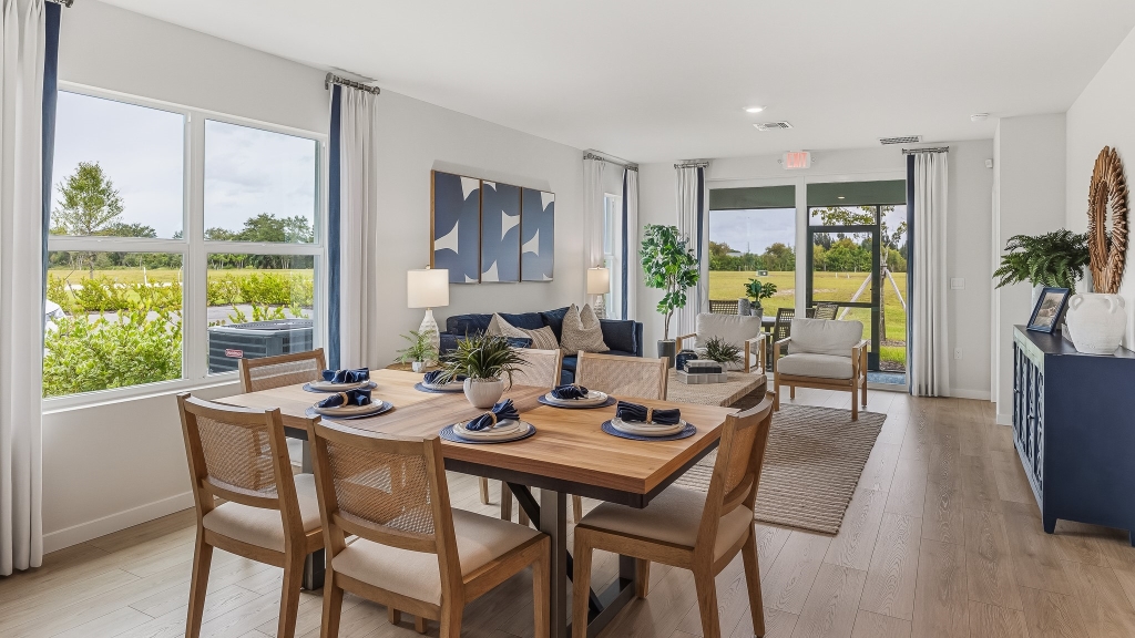 Inside of the Carrington model dining room table. To the left is a window. In this angle you can see the part of the living room and the lanai