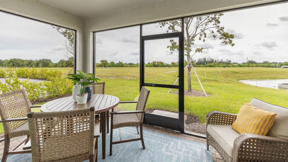 Outside of the Carrington model lanai. Outdoor furniture to relax in.