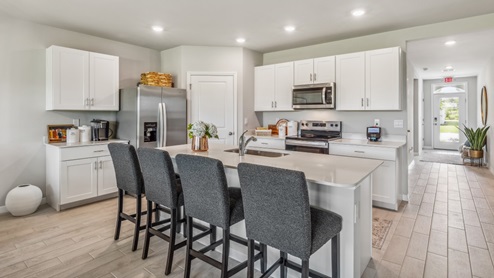 Inside of the Cali model kitchen. This photo demonstrates how the kitchen opens up to the hallway leading to the front door and other bedrooms.