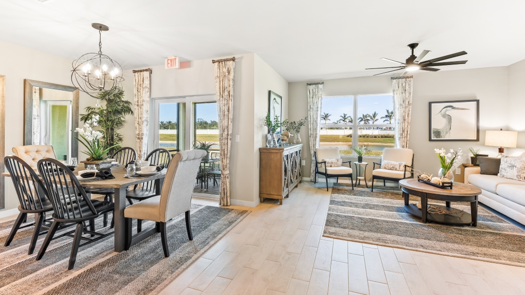 Inside the Cali model living room and dining room. This angle shows how the two spaces are connected, as well as the outdoor patio area.