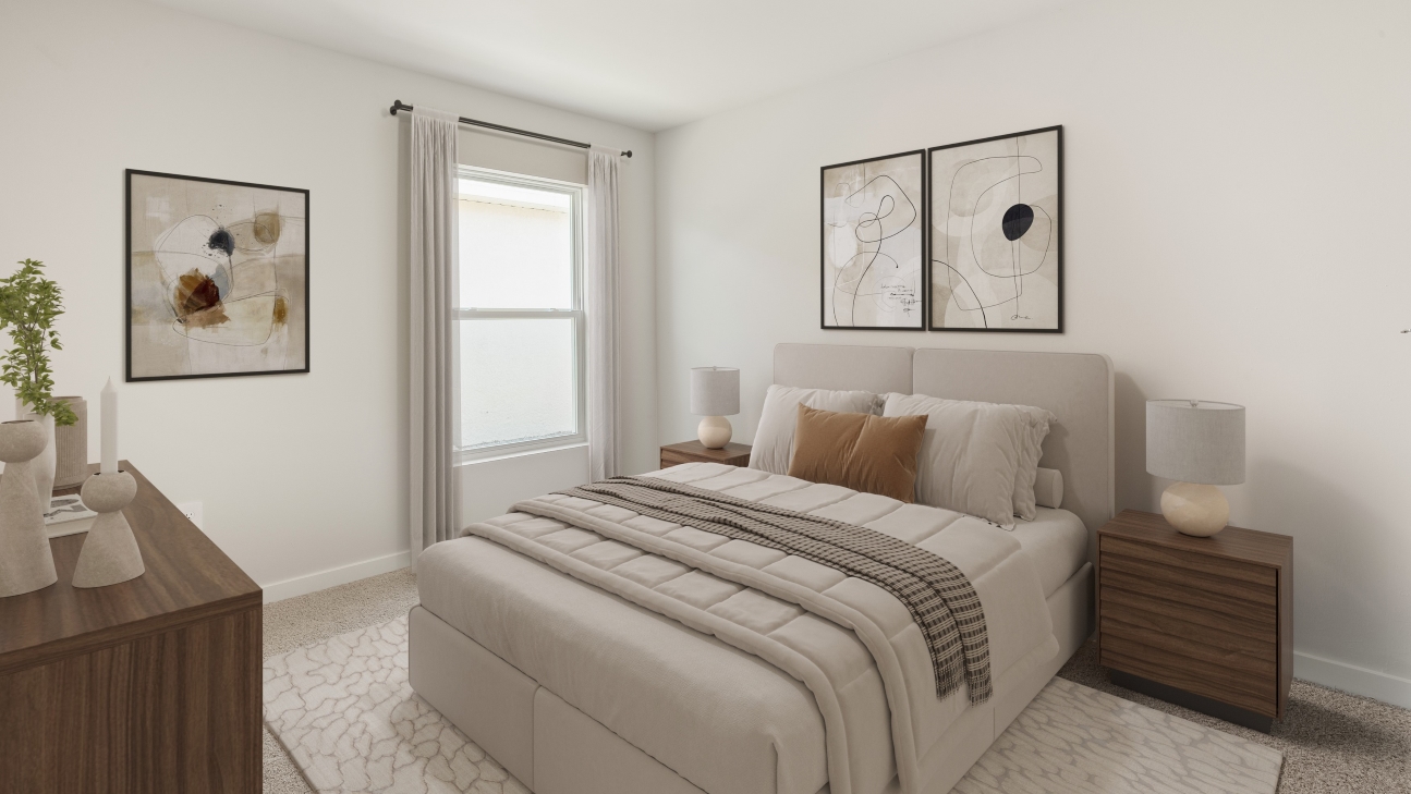 Inside the Downing model bedroom 1. Large bed with side tables on either side of the bed and a dresser across from the bed. Room also has a window.