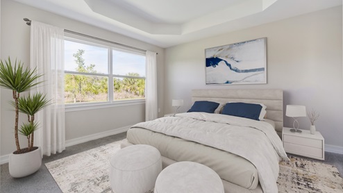 Inside of the Shelby model bedroom three. Creme carpet with off-white walls. Room contains a bed with nightstands on either side as well as two small benches at the foot of the bed. Room contains large window.