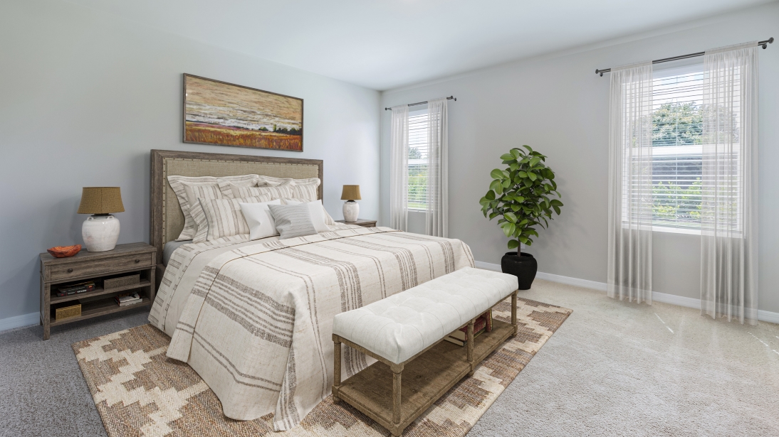 Inside the fifth bedroom of the Lakeside. Carpetted floors and gray walls with Farmhouse style décor. There is a window for viewing the landscaped area outside.