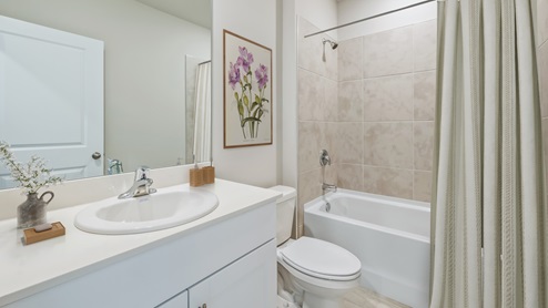 Lakeside Primary bathroom with tiled shower and white tub.