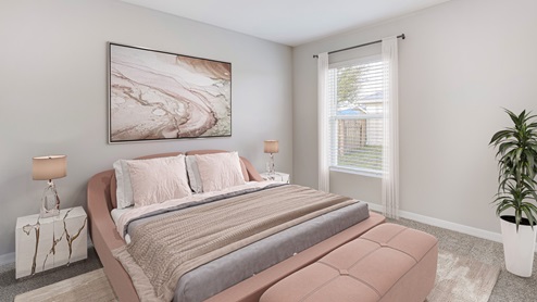 Inside of the Boardwalk bedroom three. Off-white walls and beige carpet. Room contains dusty-pink bed, small nightstands on either side of bed, and small plant in corner of the room. Room also contains a window.