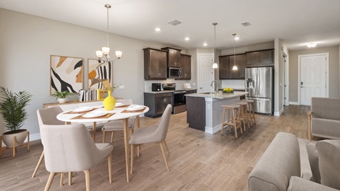 Inside the Coral home, you can see the kitchen, dining room. Cabinets are dark wood and floor is wood tiling.