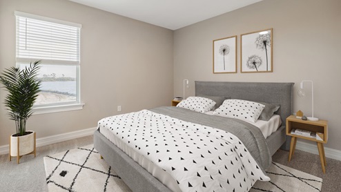 Inside the Coral third bedroom with one window. The floors are carpeted and walls are painted.