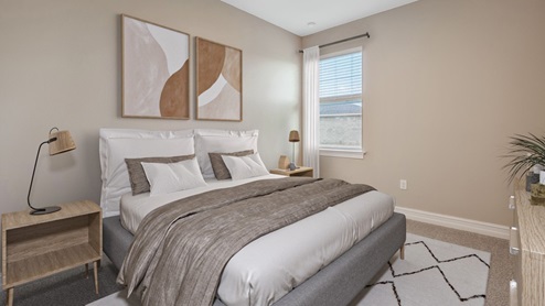 Inside the Coral fourth bedroom with one window. The floors are carpeted and walls are painted.