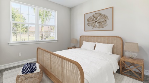 Inside the Clifton's secondary bedroom with a large window. The bedding is white with a rattan head and base board. There are two wooden side tables with lamps on each and a seat at the end of the bed.