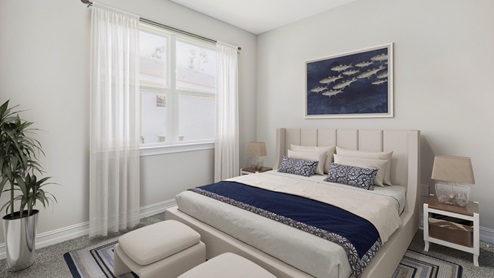 Inside the Clifton's third bedroom with a large window. The bedding is white and navy blue with a grey quilted headboard. There are side tables with lamps on each and 2 small seats at the end of the bed.