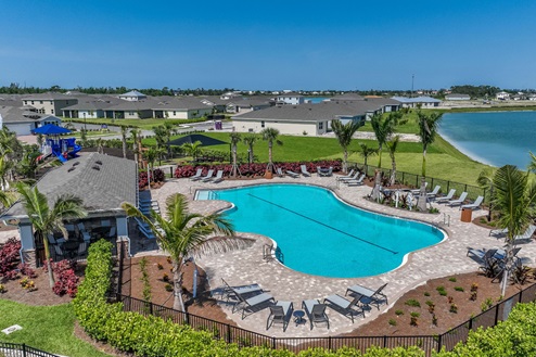 Arial view of the pool with shaded and sun seating as well as tables.