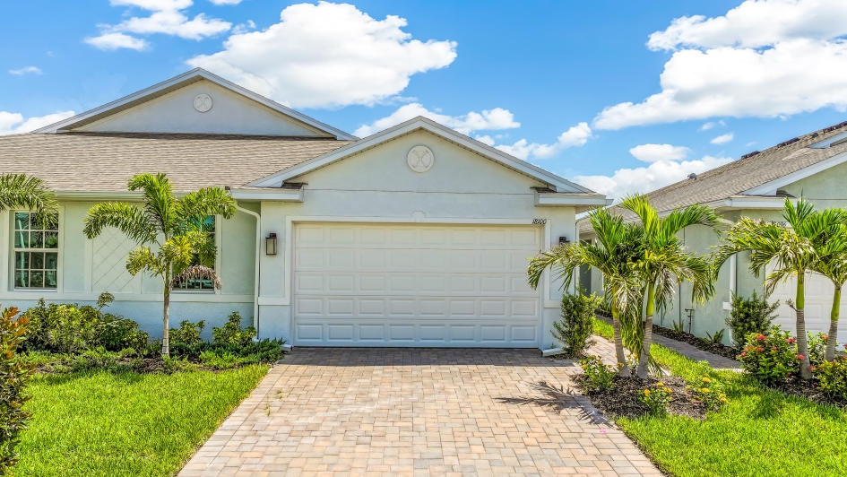 Outside of the Carrington B Model. Paver driveway and two car garage