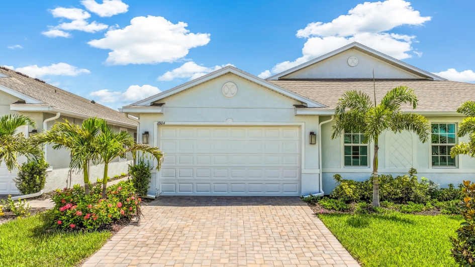 Outside of the Carrington B Model. Paver driveway and two car garage