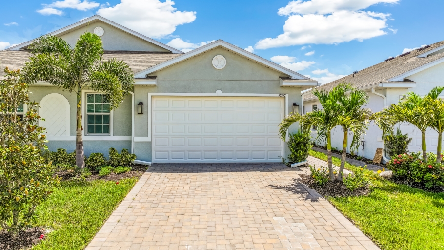 Outside of the Carrington B Model. Paver driveway and two car garage