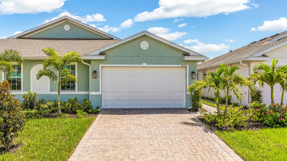 Outside of the Carrington B Model. Paver driveway and two car garage