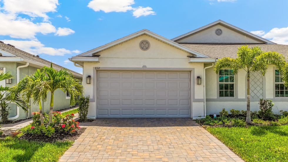 Outside of the Carrington B Model. Paver driveway and two car garage