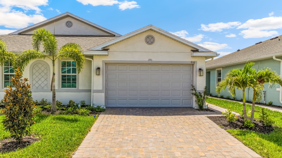 Outside of the Carrington B Model. Paver driveway and two car garage