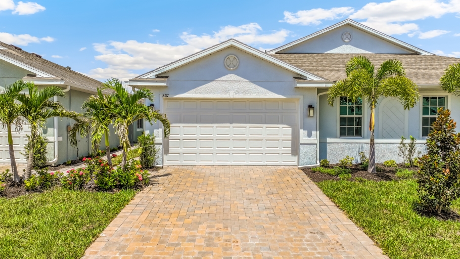 Outside of the Carrington B Model. Paver driveway and two car garage