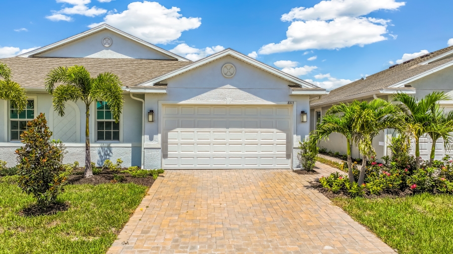 Outside of the Carrington B Model. Paver driveway and two car garage