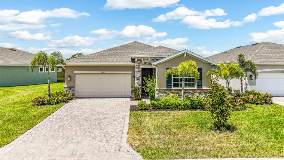 Outside of the Clifton A Model Home. Paver driveway and two car garage