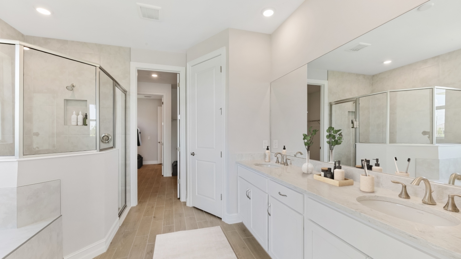 Inside of the Shelby primary bathroom. Dual vanity sinks. The bathroom is connected to the walk in closet.