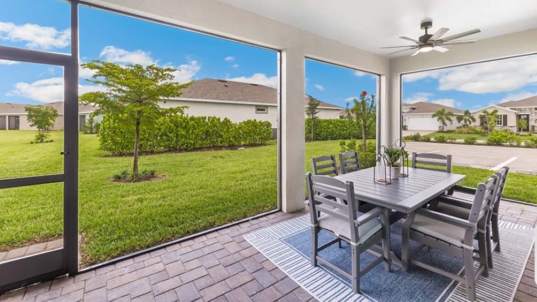 Outside of the back of the Delray model lanai. View of the lanai furniture and the back of the model.