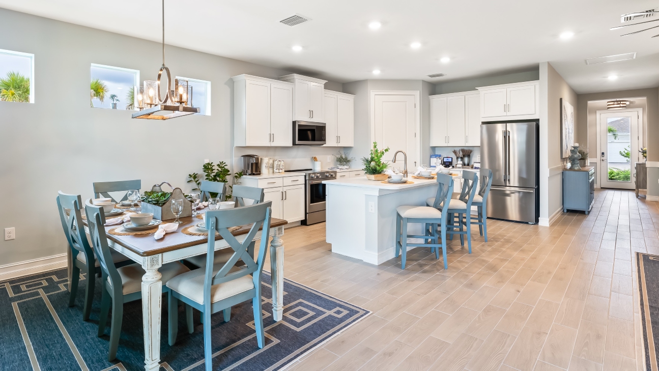 Inside of the of the Delray Model kitchen area. Kitchen has stainless steel appliances. There is bar seating in the kitchen.