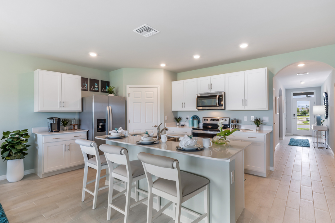 Inside of the Cali model kitchen. This photo demonstrates how the kitchen opens up to the hallway leading to the front door and other bedrooms.