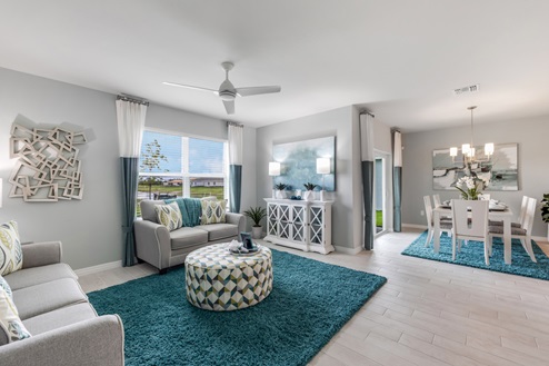 Inside of the Cali model living area. This photo demonstrates how the living area also uses an open concept and so the dining area and kitchen can be seen from the living area.
