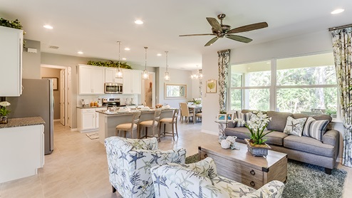 Open concept living area including the living room, kitchen with island, and dining area.