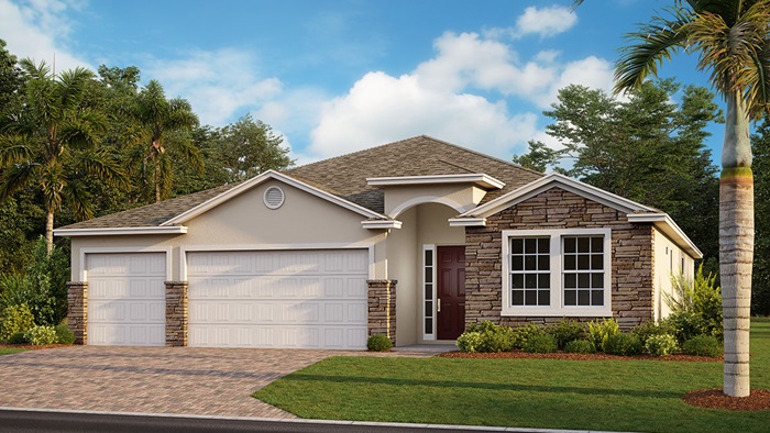 Outside of Destin D model. Yellow house with three car garage, stone accents, two small windows, front door, and stone accents. Mixed paver driveway.