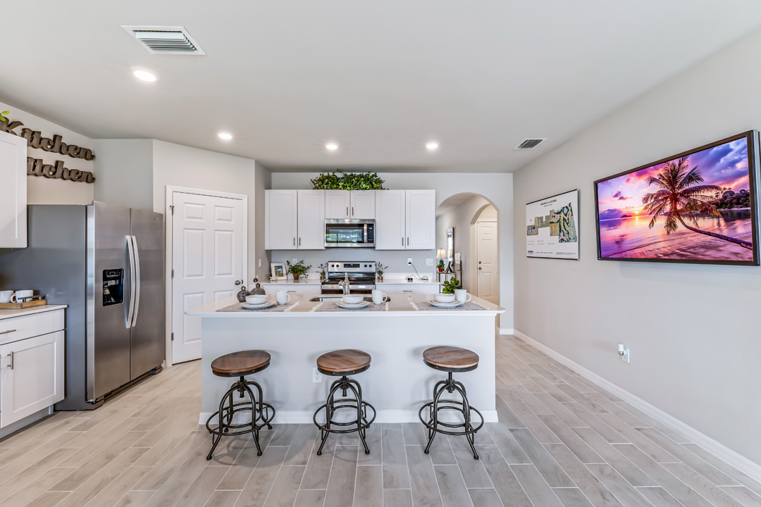 Inside of the Cali model kitchen. This angle shows the hallway leading to the other rooms and front door.