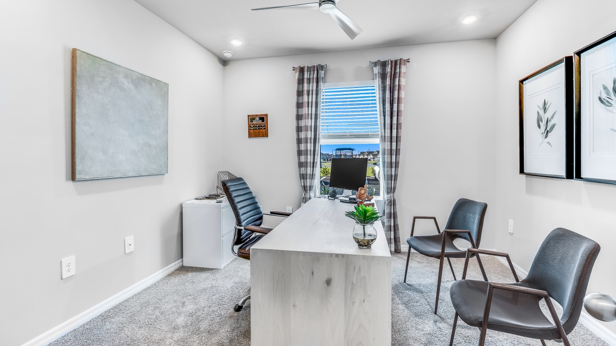 This office space is carpeted and fits a desk as well as 3 chairs. There is a window for natural lighting.