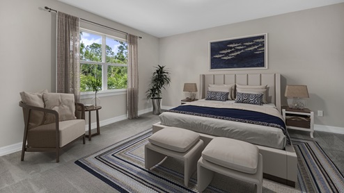 Inside of the Delray B model bedroom four. Grey carpet with off-white walls. Room contains a bed with nightstands on either side, armchair with side table next to it, and a bench at the end of the bed. Room also has a window.