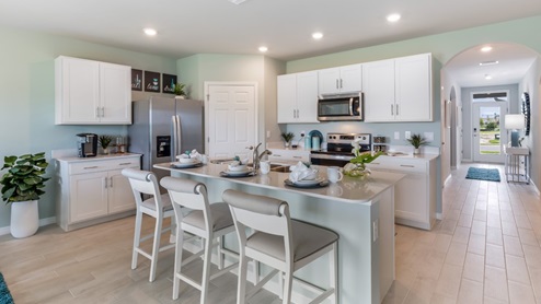 Inside of the Cali model kitchen. This photo demonstrates how the kitchen opens up to the hallway leading to the front door and other bedrooms.