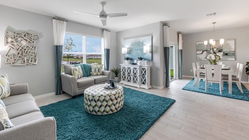 Inside of the Cali model living area. This photo demonstrates how the living area also uses an open concept and so the dining area and kitchen can be seen from the living area.