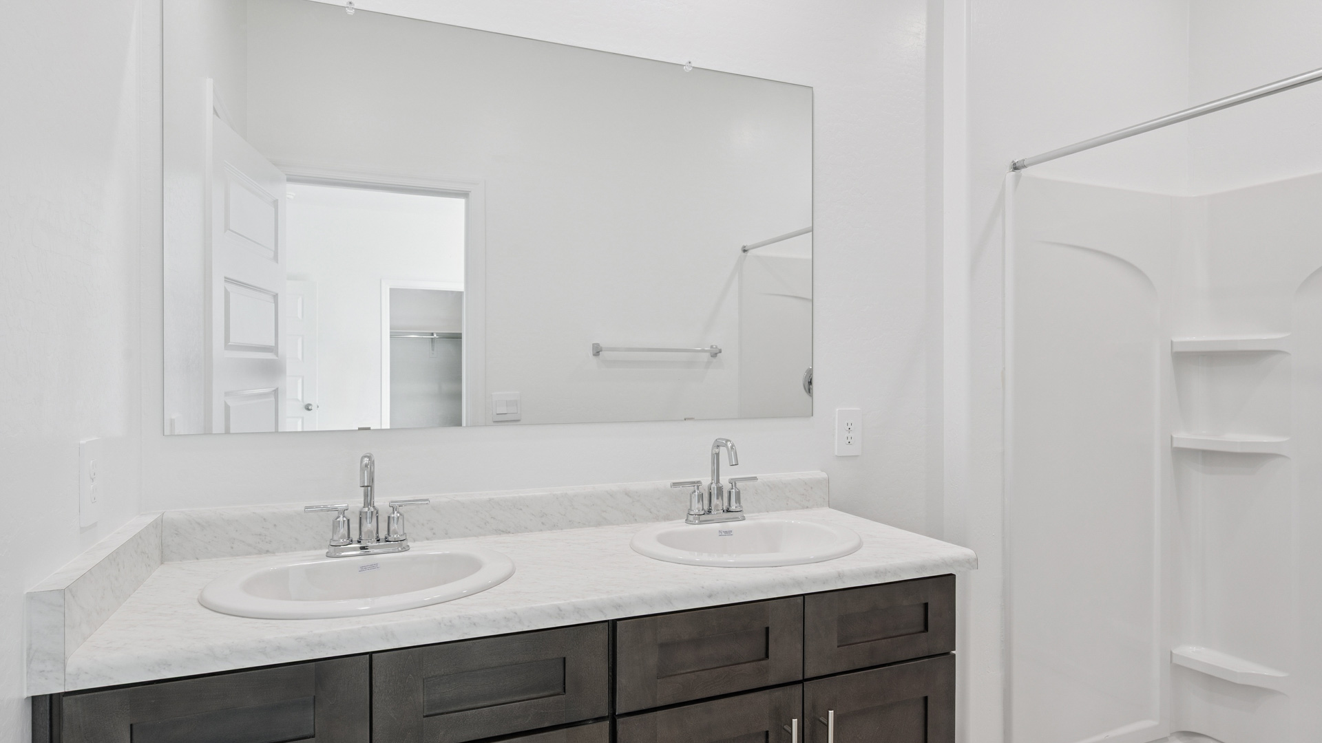 primary bathroom with dual vanities