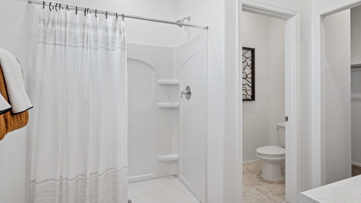 primary bathroom with dual vanities