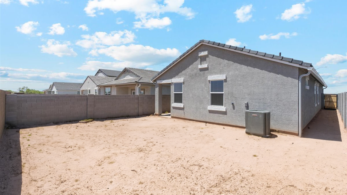 exterior with backyard overlooking side yard and gate