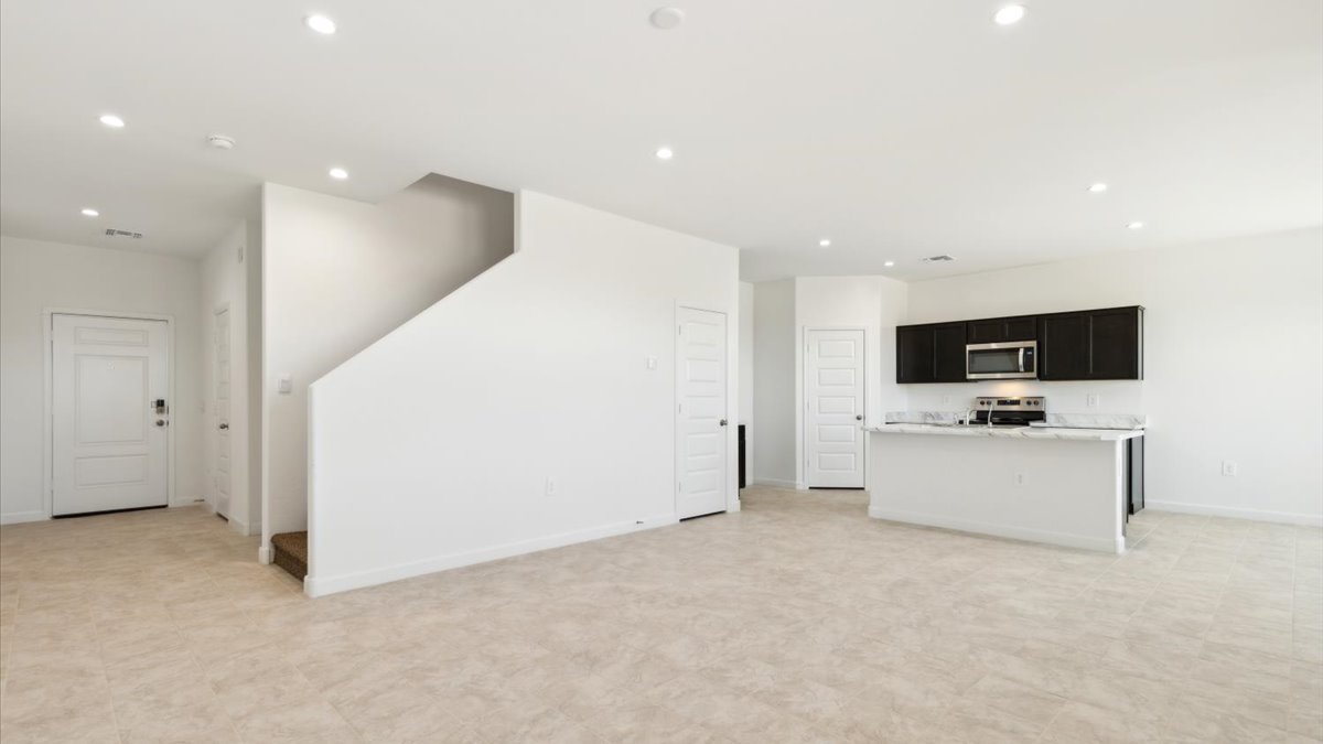 Living room overlooking the kitchen and entryway with stairwell