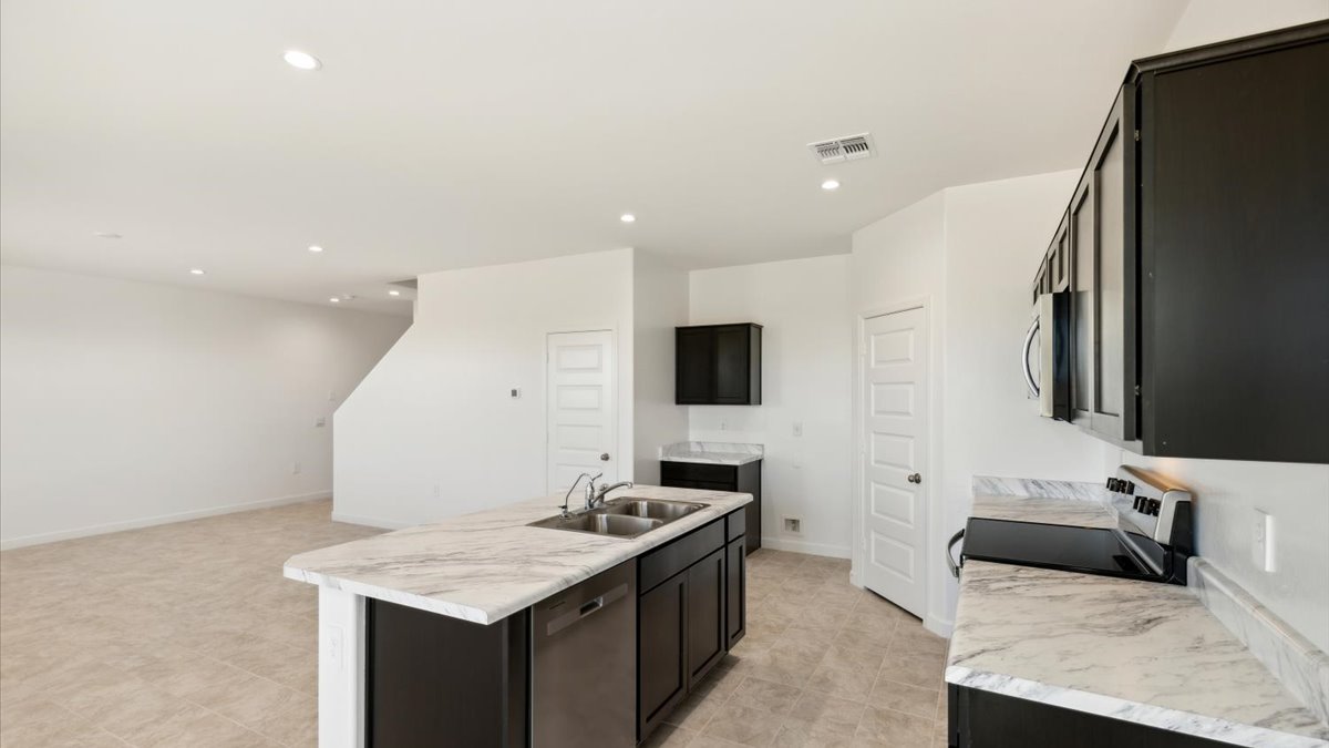 Kitchen over looking living area and stairwell