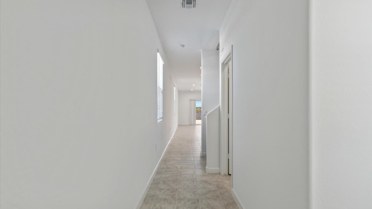 Entry hallway leading to living room and kitchen in the background.