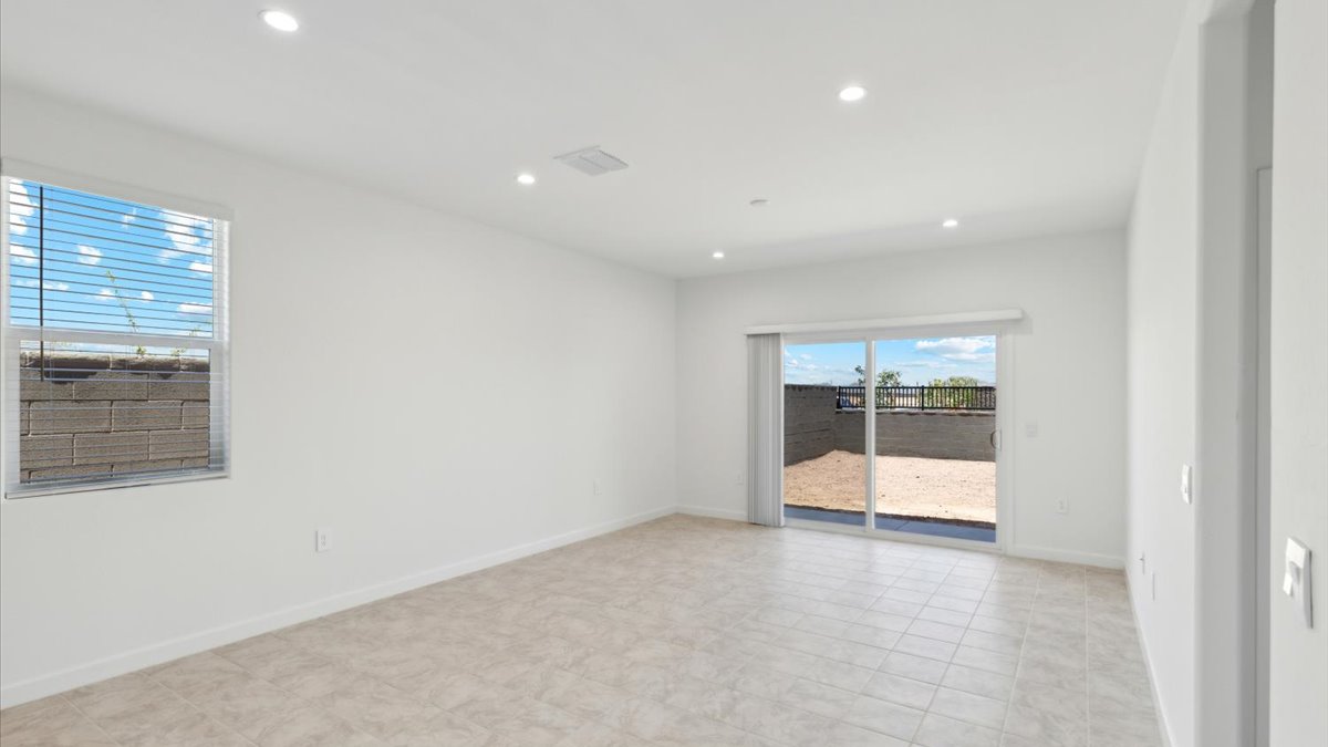 A well-organized living room that includes a kitchen and dining area, creating a warm and welcoming environment for gatherings.