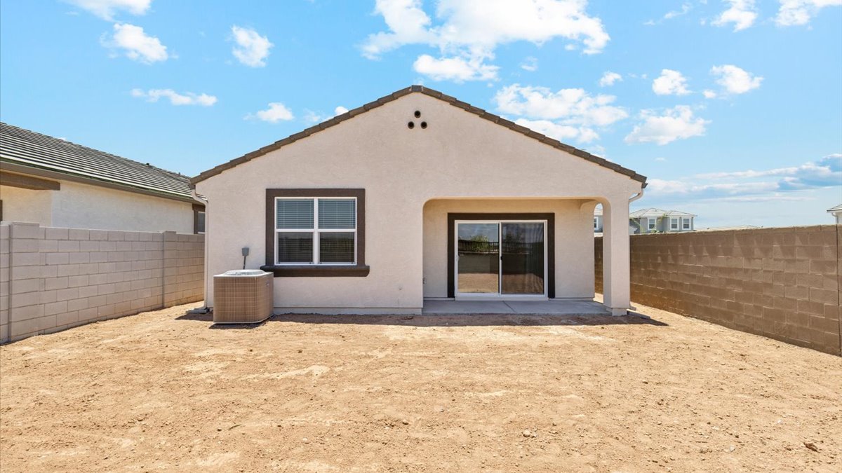 Large fenced-in backyard with a covered patio, perfect for outdoor entertaining.